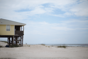 yellow beach house on stilts