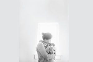 mother kissing newborn