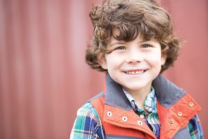 smiling young boy in vest