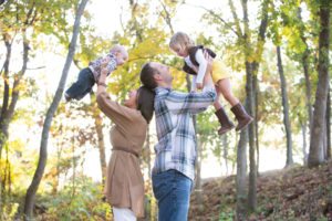parents holding kids in air