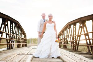 bride and groom on bridge