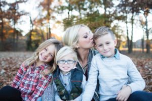 mom with kids kissing son