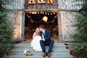 bride and groom outside of barn
