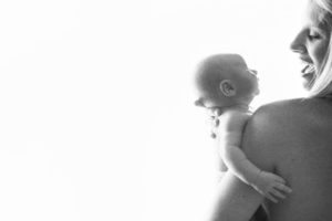 newborn and smiling mother