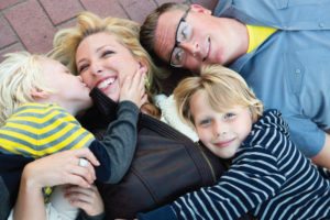 family laying on bricks