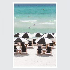 ocean with people in the water and beach chairs