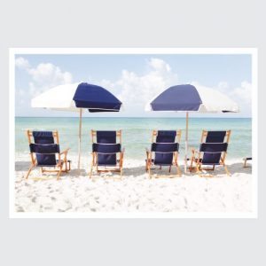 ocean with blue and white beach chairs