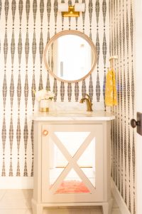 10 Beautiful Ideas for How To Use Wallpaper in Modern Home Design Schumacher black and white fern wallpaper round wood mirror grey bathroom vanity gold plumbing fixtures-5