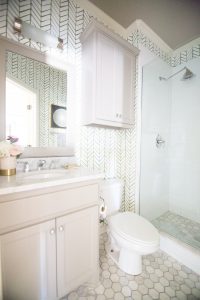 10 Beautiful Ideas for How To Use Wallpaper in Modern Home Design marble hexagon tile floor gray bathroom vanity gold hardware serena and lily wallpaper bathroom styling gold bathroom sconce-2