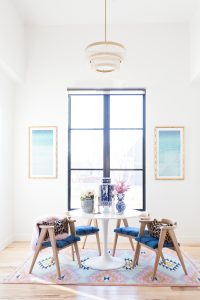 Rooms We Love Home Tour Navy and Pink Modern Glam Breakfast Nook Glittler Guide elodie rug blue and white tabletop vases gold candlesticks black windows wishbone chairs white round table colorful dining room rugs-3.jpg-1.jpg