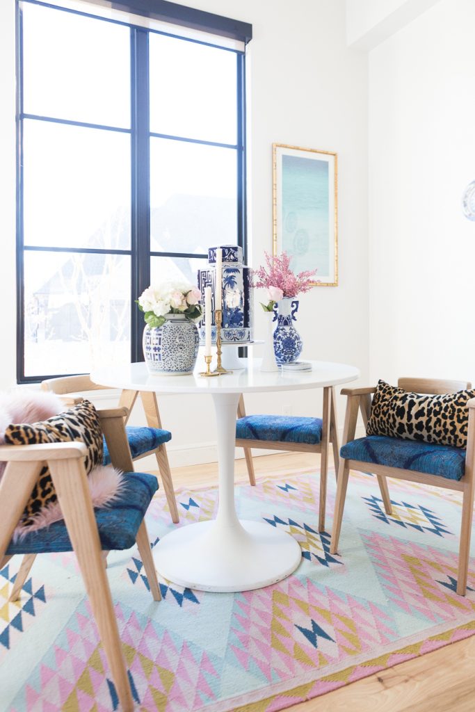 Rooms We Love Home Tour Navy and Pink Modern Glam Breakfast Nook Glittler Guide elodie rug blue and white tabletop vases gold candlesticks black windows wishbone chairs white round table colorful dining room rugs-3.jpg-1.jpg