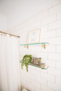 Modern Glam Blush Girls Bathroom Design gold hexagon mirror blush cabinets gold hardware white hexagon floor glass shelves pink bathroom cabinets gold orb sconce-1-3