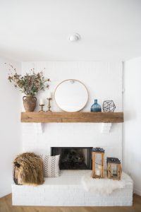 Tulsa Remodel Reveal Modern White Farmhouse white brick fireplace wood beam mantle gold round mirror-1-2