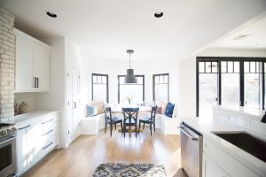 Tulsa Remodel Reveal Modern White Farmhouse with Black WIndows and Doors built in banquette window seat black pendant dining room brick hood kitchen black hardware white kitchen-1