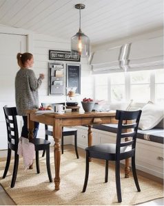 How To Design A Beautiful Kitchen Banquette Pottery Barn pendant wood table white roman shades with boder black farmhouse dining chairs shiplap walls