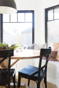 How to Design a Beautiful Kitchen Banquette modern farmhouse black dining room chairs oval wood pedestal table IKEA Hektar black pendant black windows-1-3