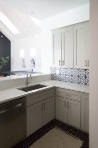 Affordable Ceramic Patterned Tile Backsplash affordable cement tile lookalike black and white patterned tile backsplash open wood shelves kitchen open wood shelves styling ideas how to style open wood shelving blue west elm vase wooden picture frames greige cabinets