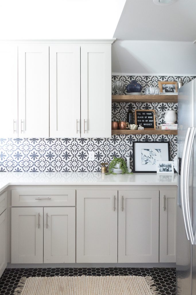 Affordable Ceramic Patterned Tile Backsplash affordable cement tile lookalike black and white patterned tile backsplash open wood shelves kitchen open wood shelves styling ideas how to style open wood shelving blue west elm vase wooden picture frames greige cabinets