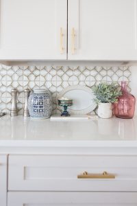 Affordable Ceramic Patterned Tile Backsplash affordable cement tile lookalike black and white patterned tile backsplash open wood shelves kitchen open wood shelves styling ideas how to style open wood shelving blue west elm vase wooden picture frames greige cabinets