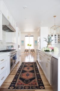 Affordable Ceramic Patterned Tile Backsplash affordable cement tile lookalike black and white patterned tile backsplash open wood shelves kitchen open wood shelves styling ideas how to style open wood shelving blue west elm vase wooden picture frames greige cabinets