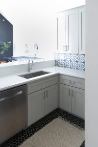 Affordable Ceramic Patterned Tile Backsplash affordable cement tile lookalike black and white patterned tile backsplash open wood shelves kitchen open wood shelves styling ideas how to style open wood shelving blue west elm vase wooden picture frames greige cabinets