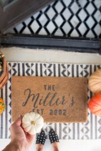 Loveliest Looks of Fall Home Tour Beautiful Fall Home Decor and Fall Fashion Ideas layered front porch rugs with a personalized froont door mat and fall pumpkins and mums