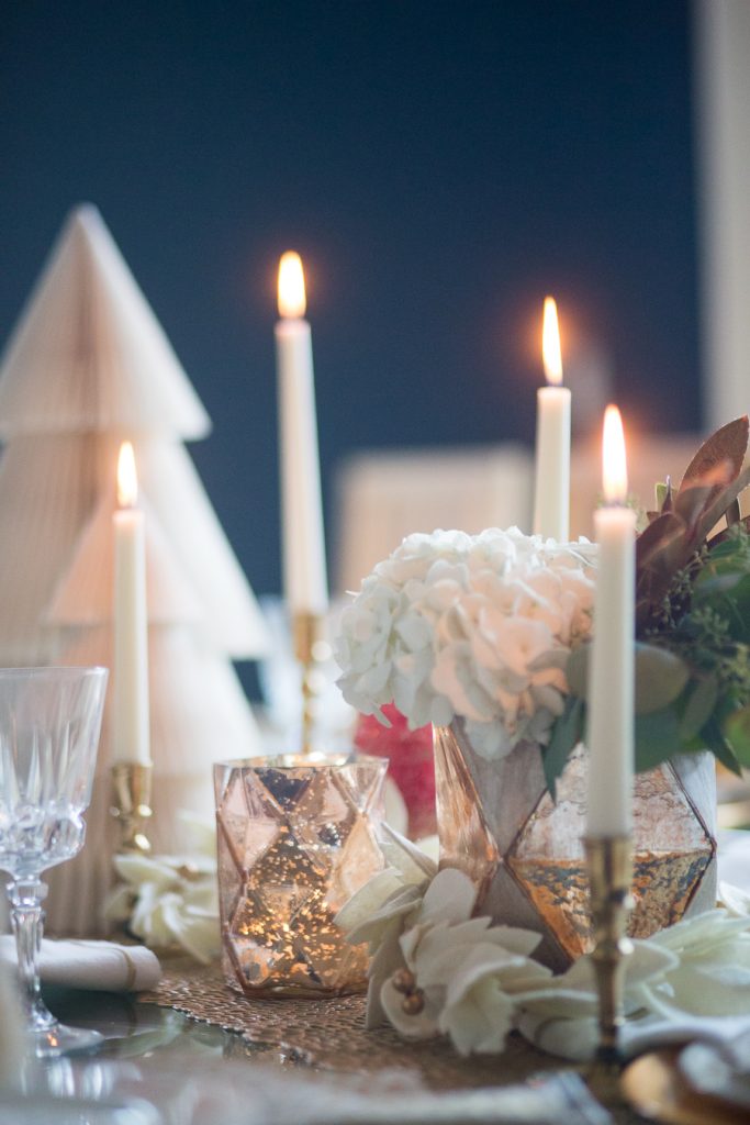 Budget Friendly Holiday Decor from Walmart Christmas tablescape with gold candlesticks and floral arrangements in a hexagon gold vase from West Elm