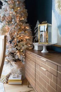 Budget Friendly Holiday Decor from Walmart Christmas tablescape with gold candlesticks and floral arrangements in a hexagon gold vase from West Elm