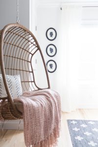 Easy DIY $5 children's silhouette framed art woven hanging chair hanging in a teen room with a black shiplap wall