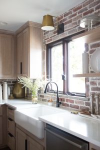 CC and Mike Kane Project Remodel Reveal rift sawn white oak wood kitchen cabinets with marble ountertops arteriors pendant lighting black hardware black stove with gold hardware loren kitchen runner