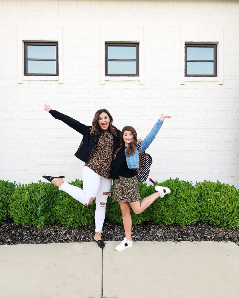 Back-To-School-with-Walmart-Part-Two-mother-and-daughter-in-leopard-shirt-and-skirt-with-jean-jackets-from-Walmart-in-front-of-a-white-brick-walmart