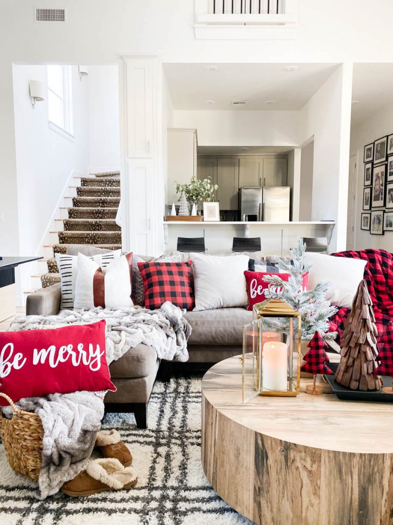 Affordable Buffalo Plaid Holiday Pillows and Decor buffalo plaid pillows and tabletop Christmas trees on a round wood coffee table-10