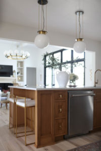 CC and MIke Kitchen Remodel Reveal large natural wood island with quartz countertops and gold bar stools black and gold pendants Ann sacks patterned backsplash gold Brizo faucet large Kallista stainless steel sink open floorpan