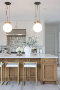 CC and MIke Kitchen Remodel Reveal large natural wood island with quartz countertops and gold bar stools black and gold pendants Ann sacks patterned backsplash gold Brizo faucet large Kallista stainless steel sink open floorpan