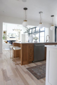 CC and MIke Kitchen Remodel Reveal large natural wood island with quartz countertops and gold bar stools black and gold pendants Ann sacks patterned backsplash gold Brizo faucet large Kallista stainless steel sink open floorpan