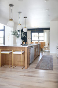 CC and MIke Kitchen Remodel Reveal large natural wood island with quartz countertops and gold bar stools black and gold pendants Ann sacks patterned backsplash gold Brizo faucet large Kallista stainless steel sink open floorpan