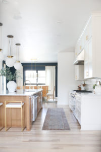 CC and MIke Kitchen Remodel Reveal large natural wood island with quartz countertops and gold bar stools black and gold pendants Ann sacks patterned backsplash gold Brizo faucet large Kallista stainless steel sink open floorpan