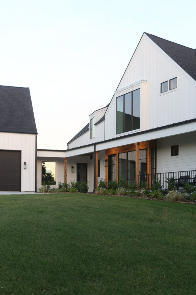 CC and Mike 2020 Project Recap and 2021 PREVIEW white modern farmhouse exterior with black aluminum windows and cedar accents lake house